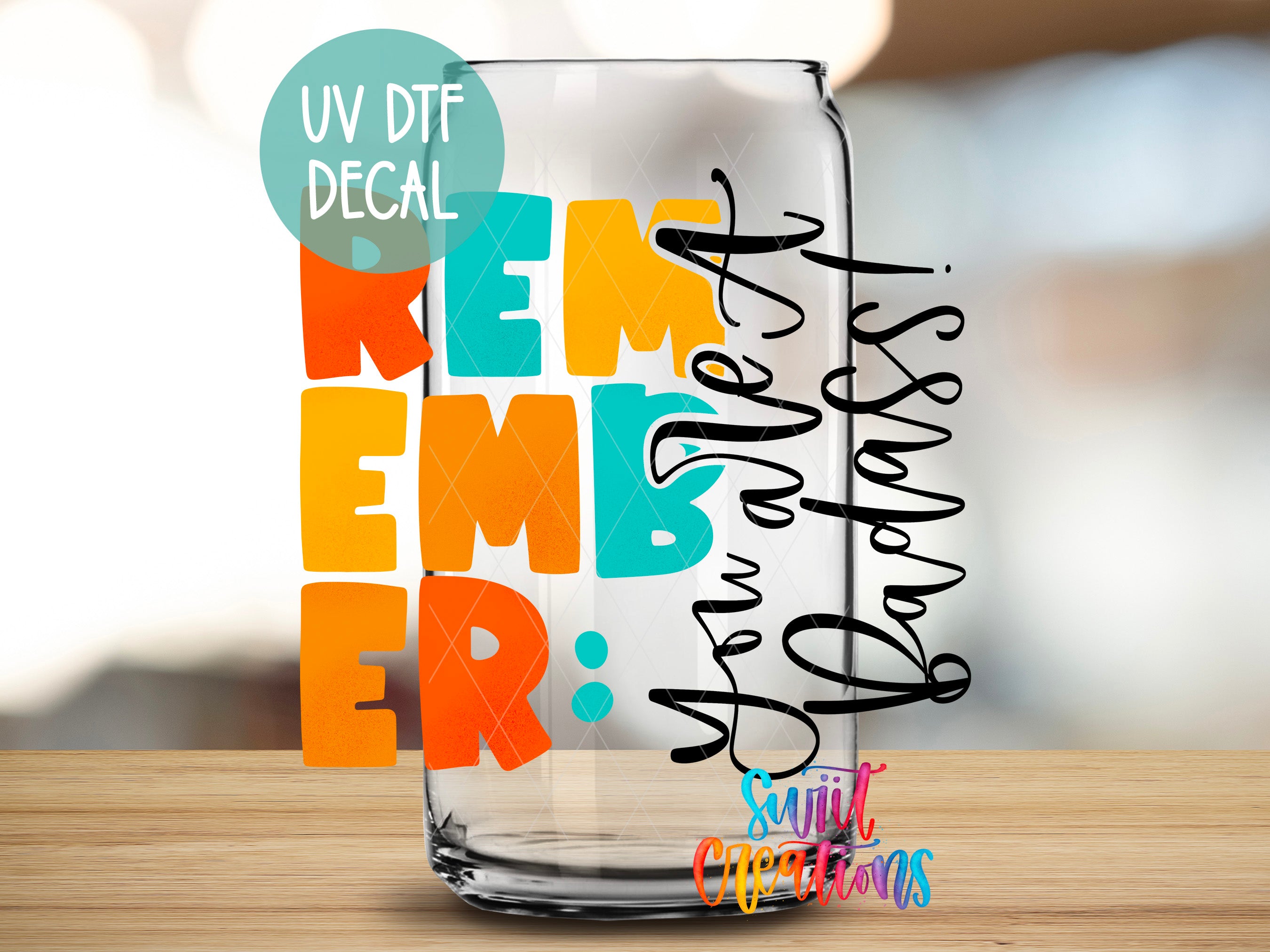 a glass with some writing on it sitting on a table