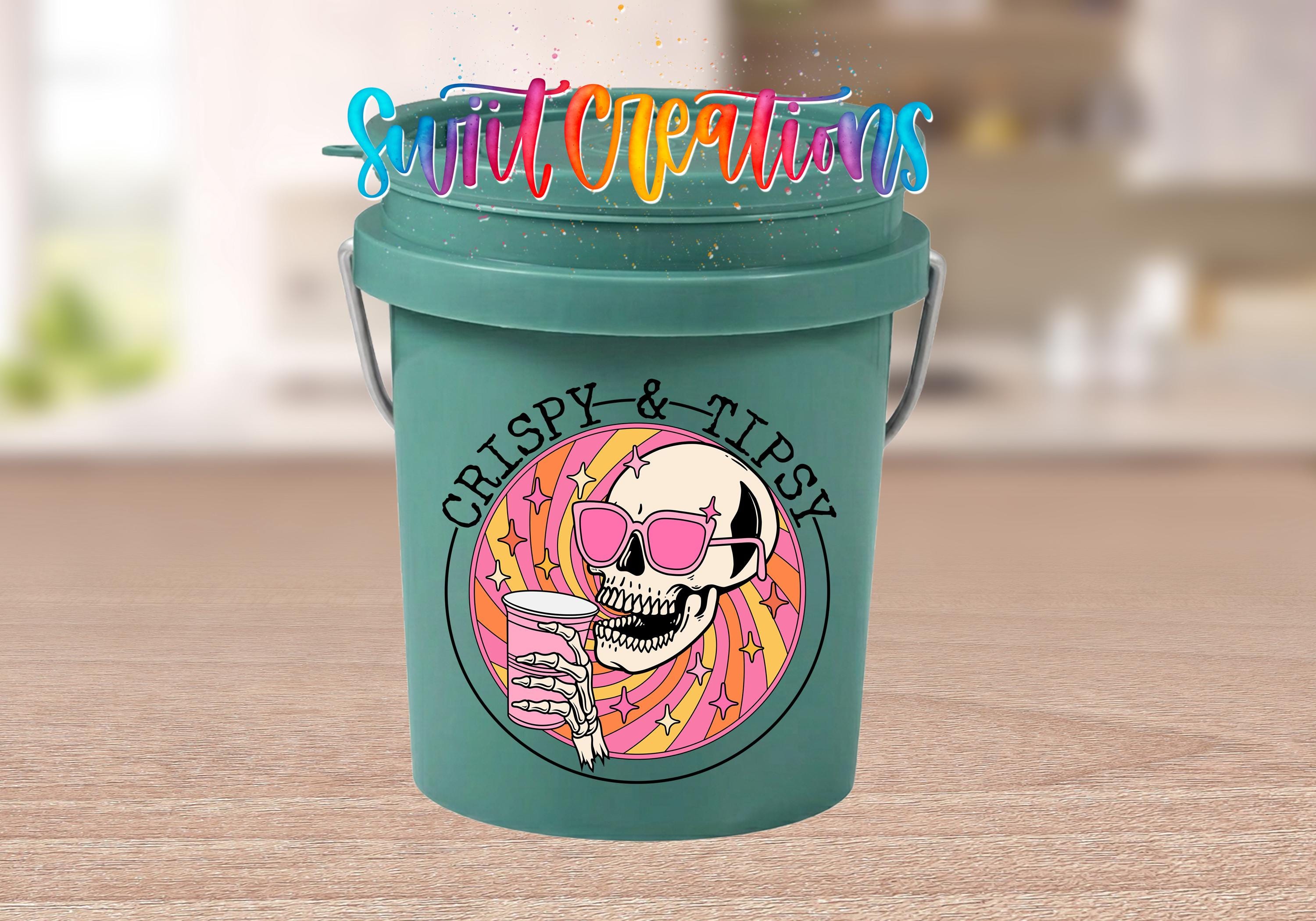 A green bucket with a skull wearing sunglasses and holding a drink, surrounded by colorful text and graphics.