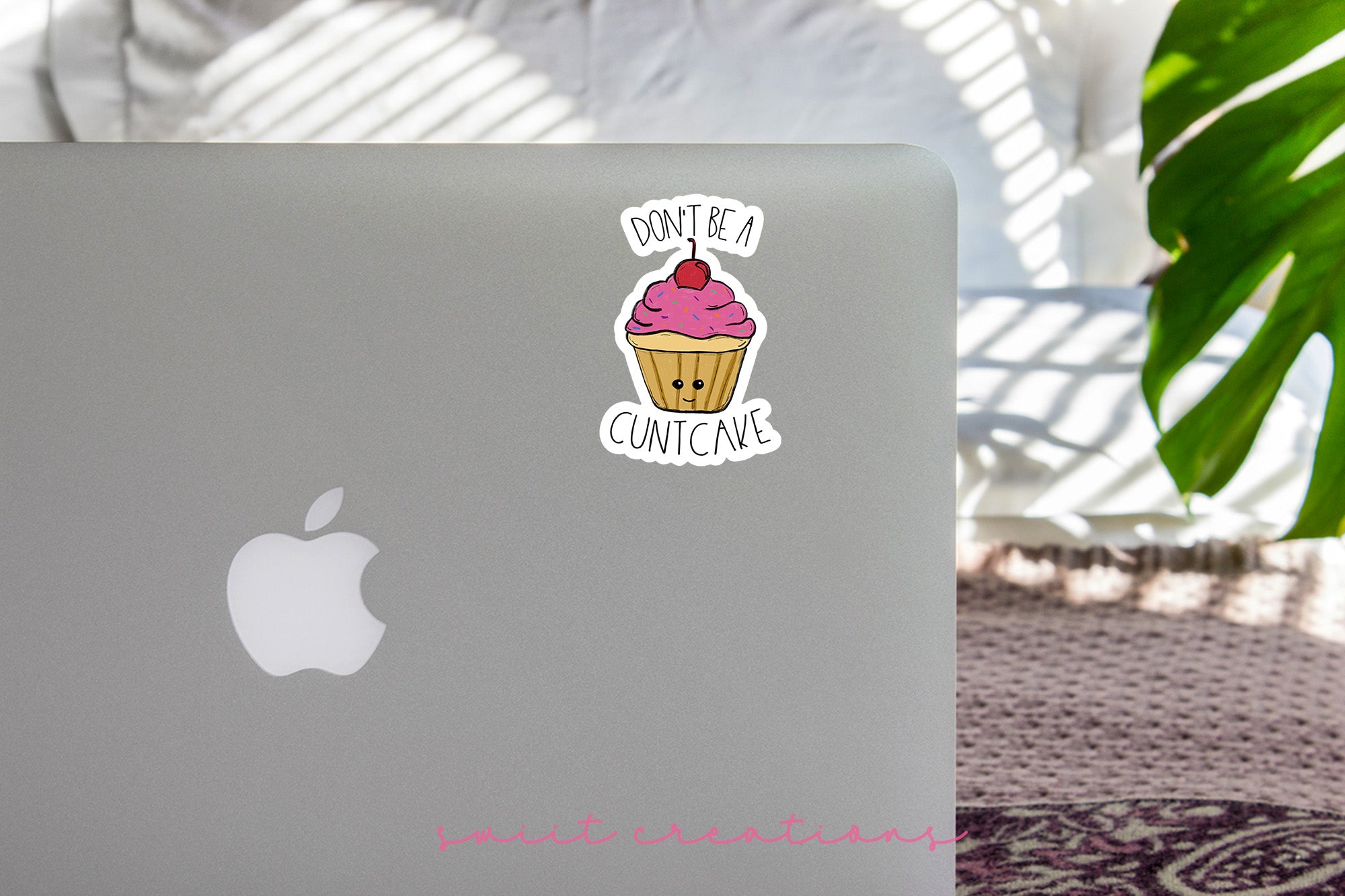 a laptop with a sticker of a cupcake on it