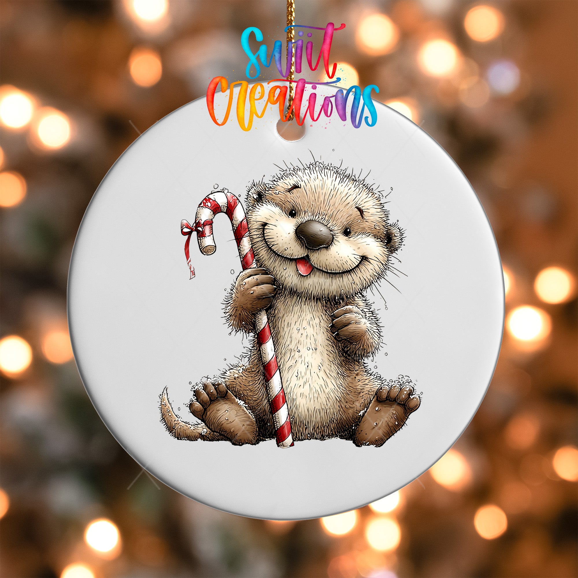 A round ornament featuring a cartoon image of an otter holding a candy cane.