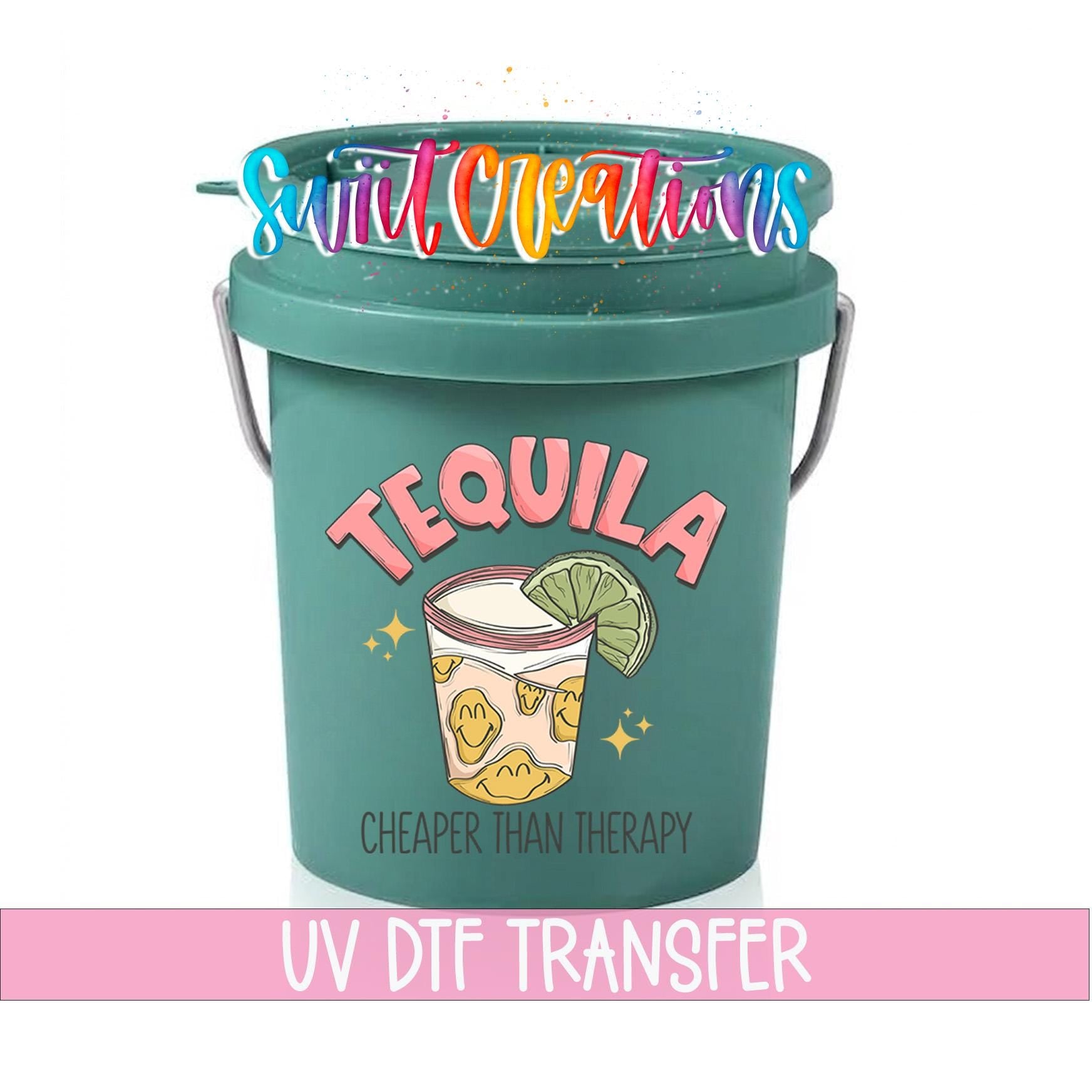 A green bucket with a tequila-themed design and the text "UV DFT TRANSFER" printed on it.