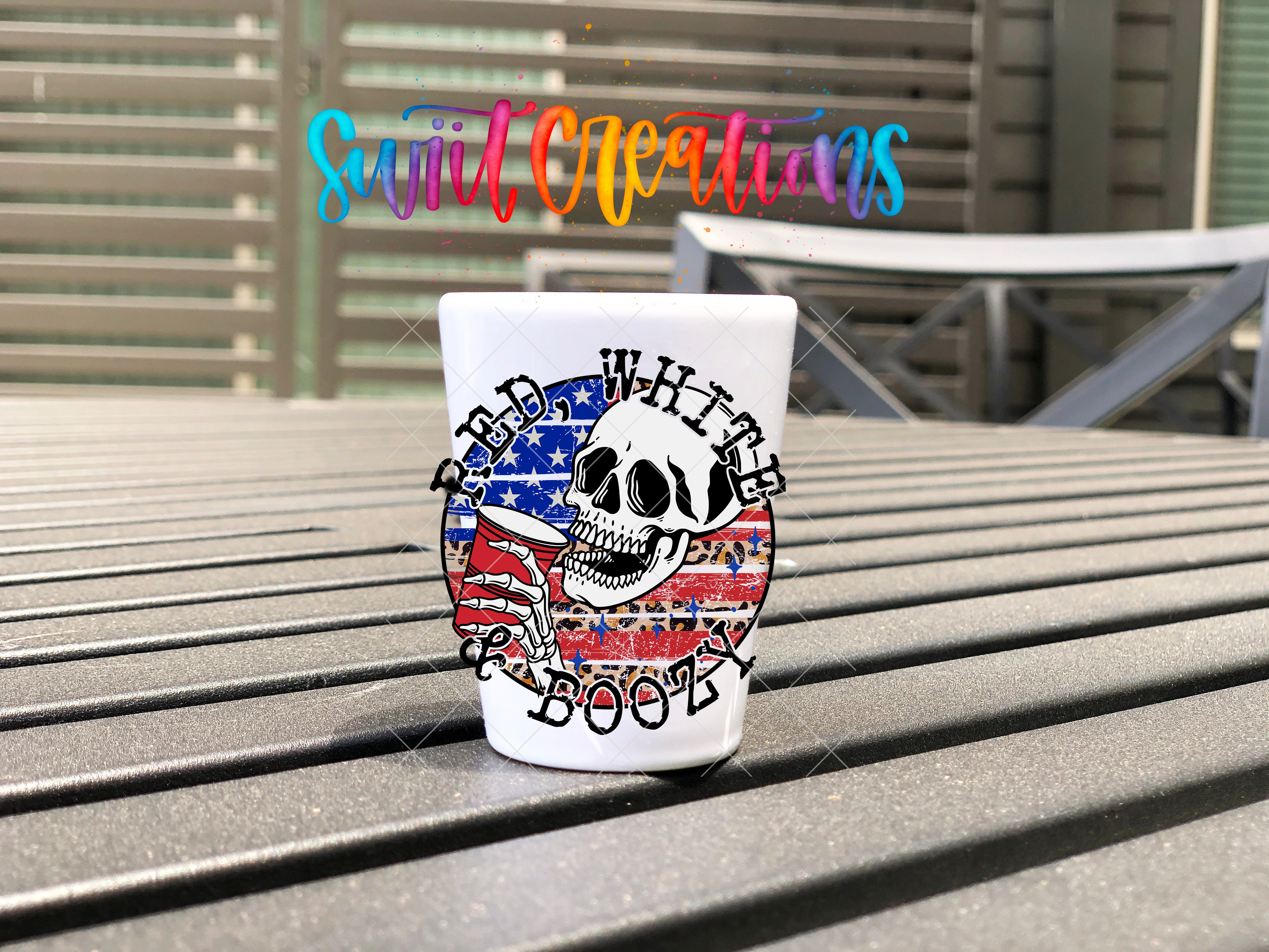A white mug with a skull design and the text "BAD WHITE BOOT" printed on it, placed on a wooden surface.