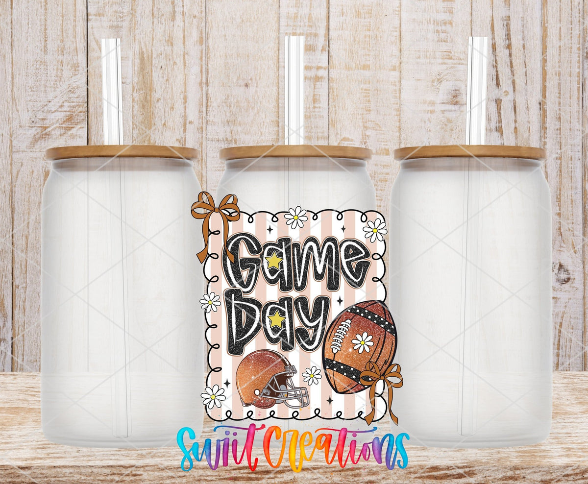 Football Game Day UV DTF transfer applied to a clear glass can set from Swiit Creations