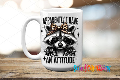 Funny Raccoon Apparently I Have An Attitude UV DTF transfer displayed on a white ceramic mug from Swiit Creations
