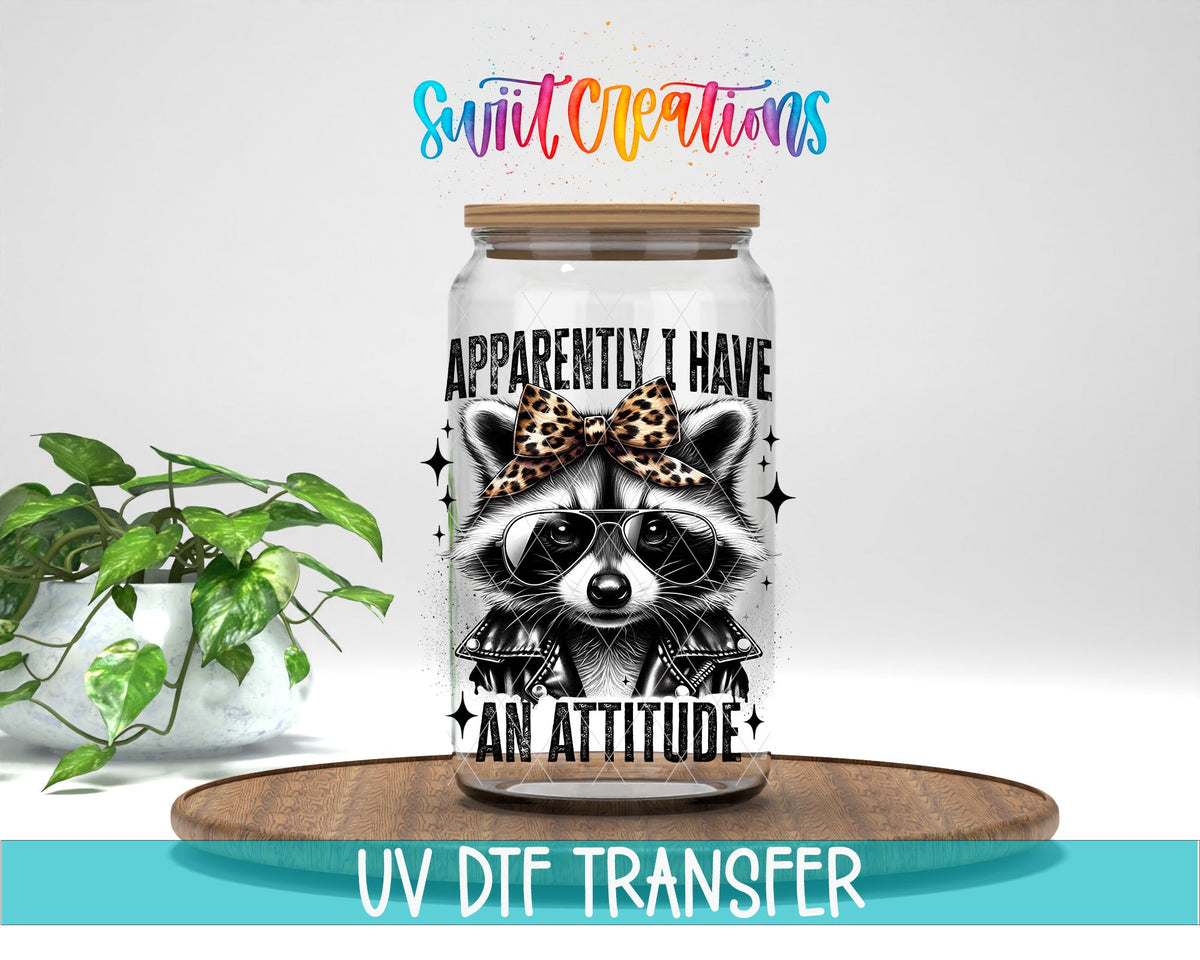 Funny Raccoon Apparently I Have An Attitude UV DTF transfer displayed on a clear jar mockup from Swiit Creations