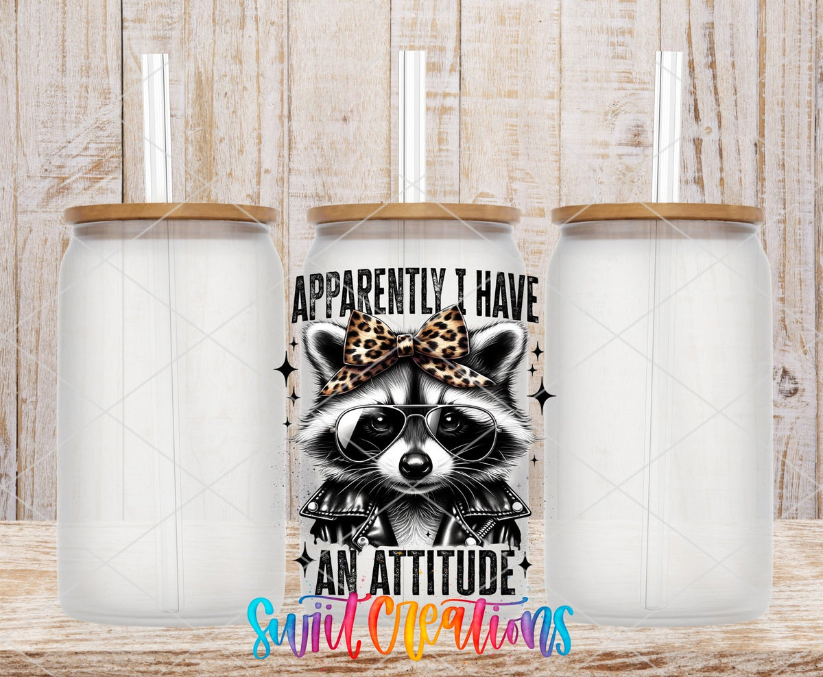 Funny Raccoon Apparently I Have An Attitude UV DTF transfer applied to a clear glass can set from Swiit Creations