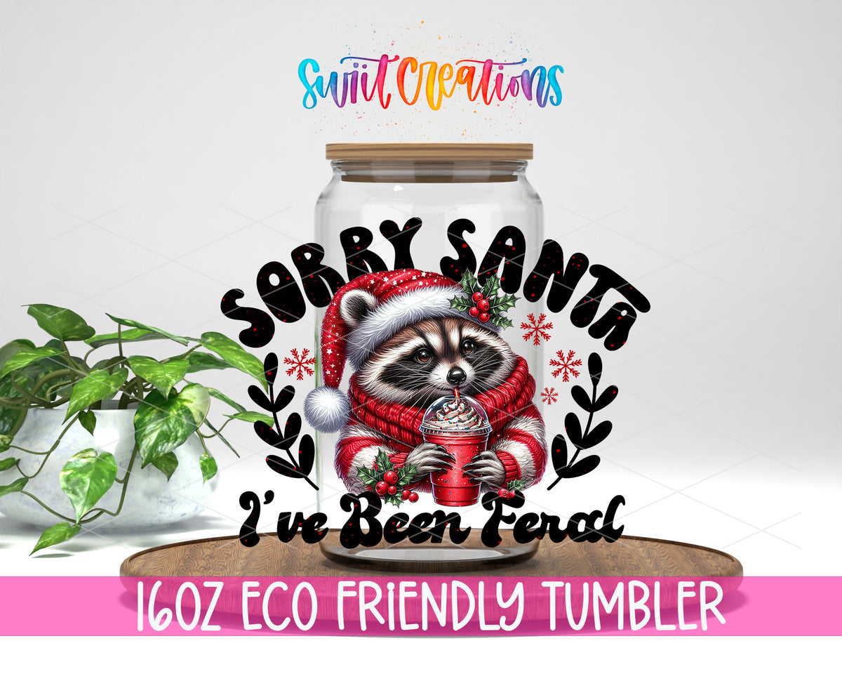 Sorry Santa I Have Been Feral Raccoon design on a 16 oz clear glass tumbler with bamboo lid