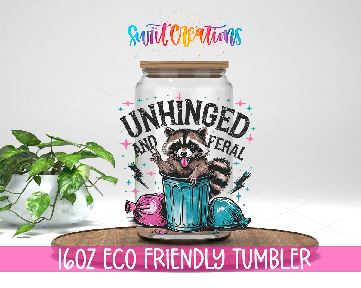 Unhinged and Feral Raccoon design on a 16 oz clear glass tumbler with bamboo lid