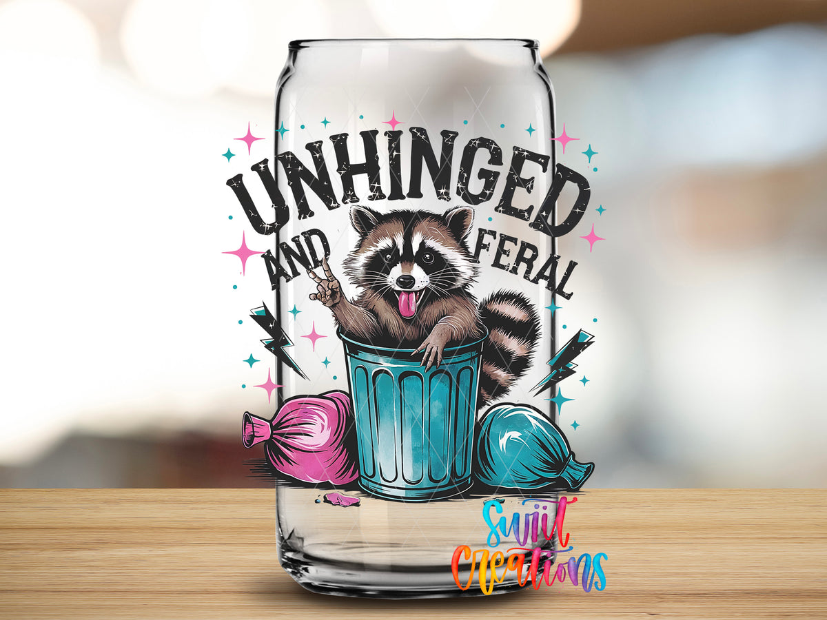 Unhinged and Feral Raccoon design close-up on a clear glass can tumbler
