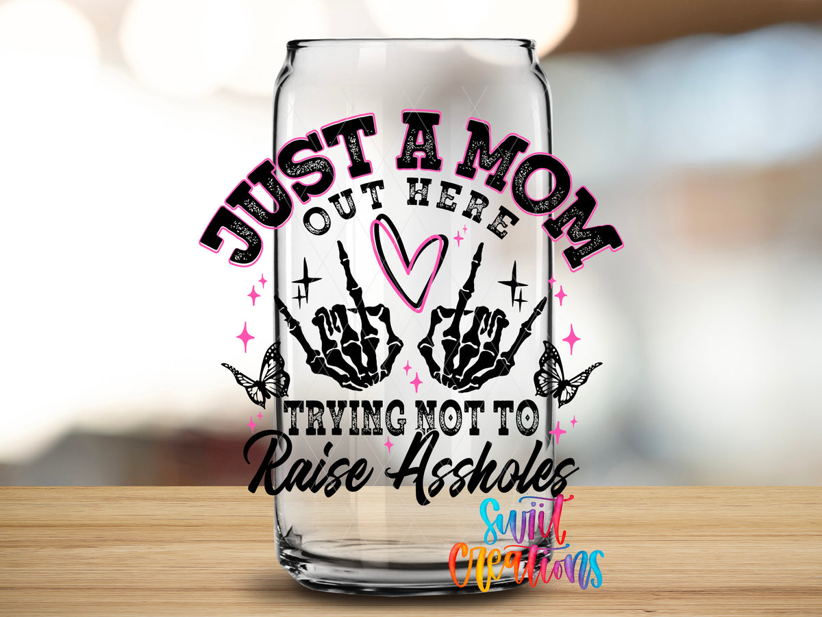 Trying Not to Raise Assholes design close-up on a clear glass can tumbler