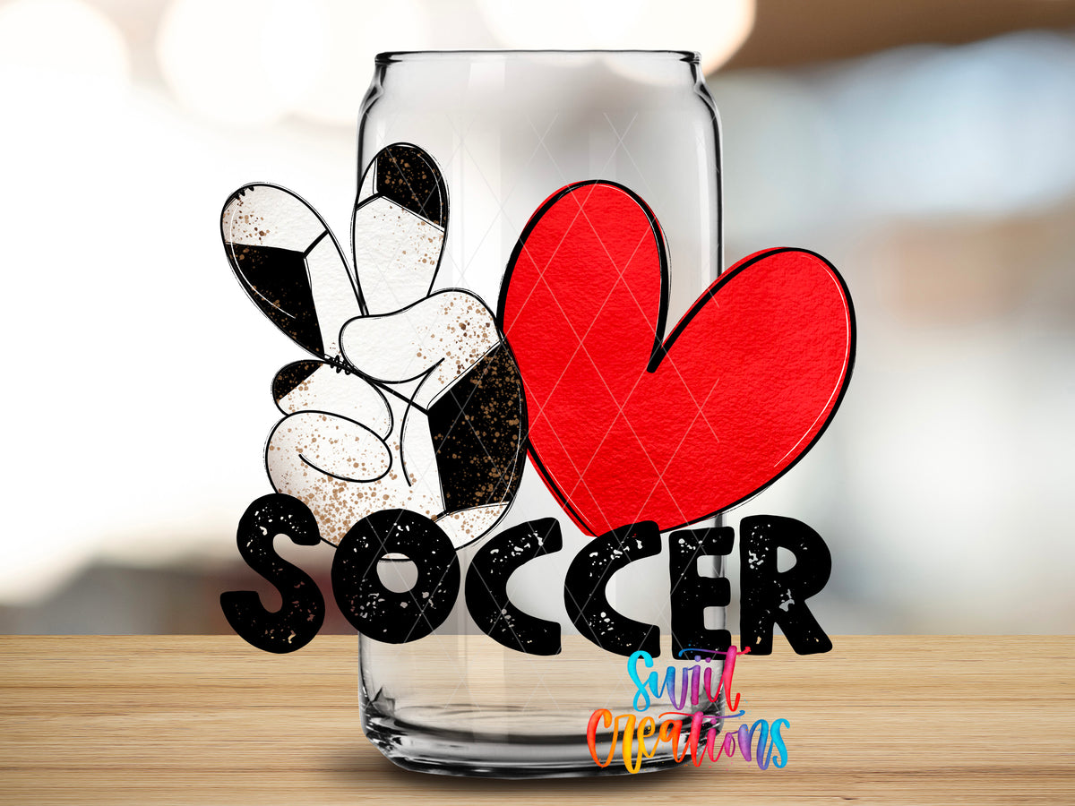 Peace Love Soccer design close-up on a clear glass can tumbler