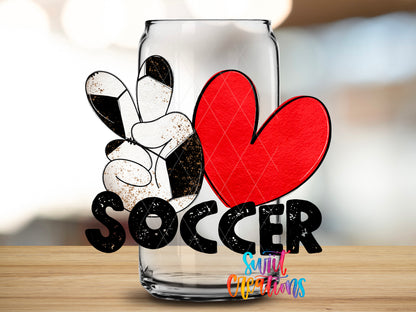 Peace Love Soccer design close-up on a clear glass can tumbler