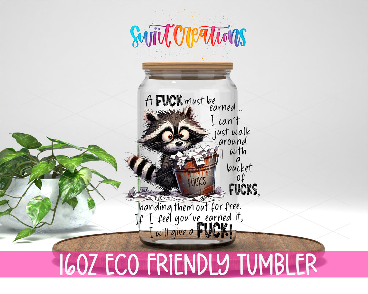 A Fuck Must Be Earned design on a 16 oz clear glass tumbler with bamboo lid