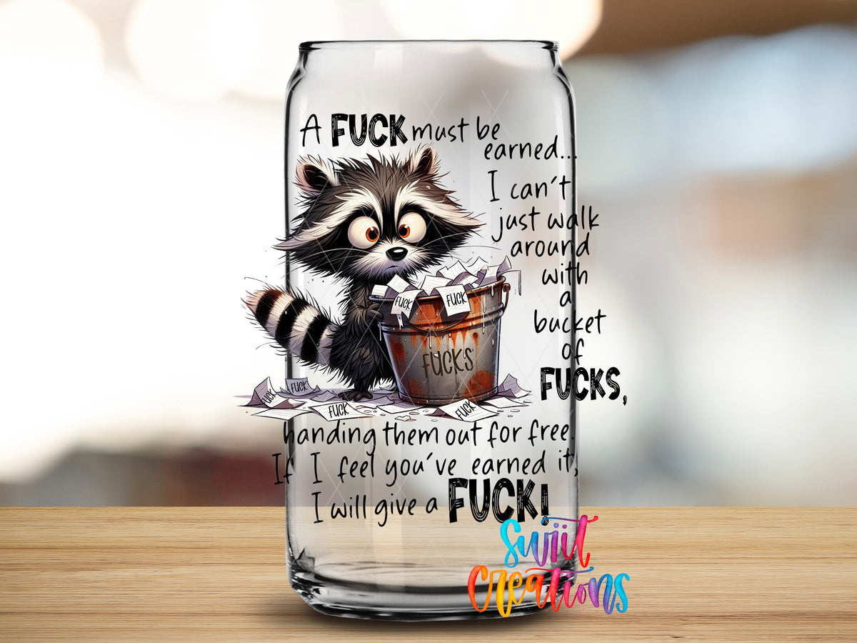 A Fuck Must Be Earned design close-up on a clear glass can tumbler