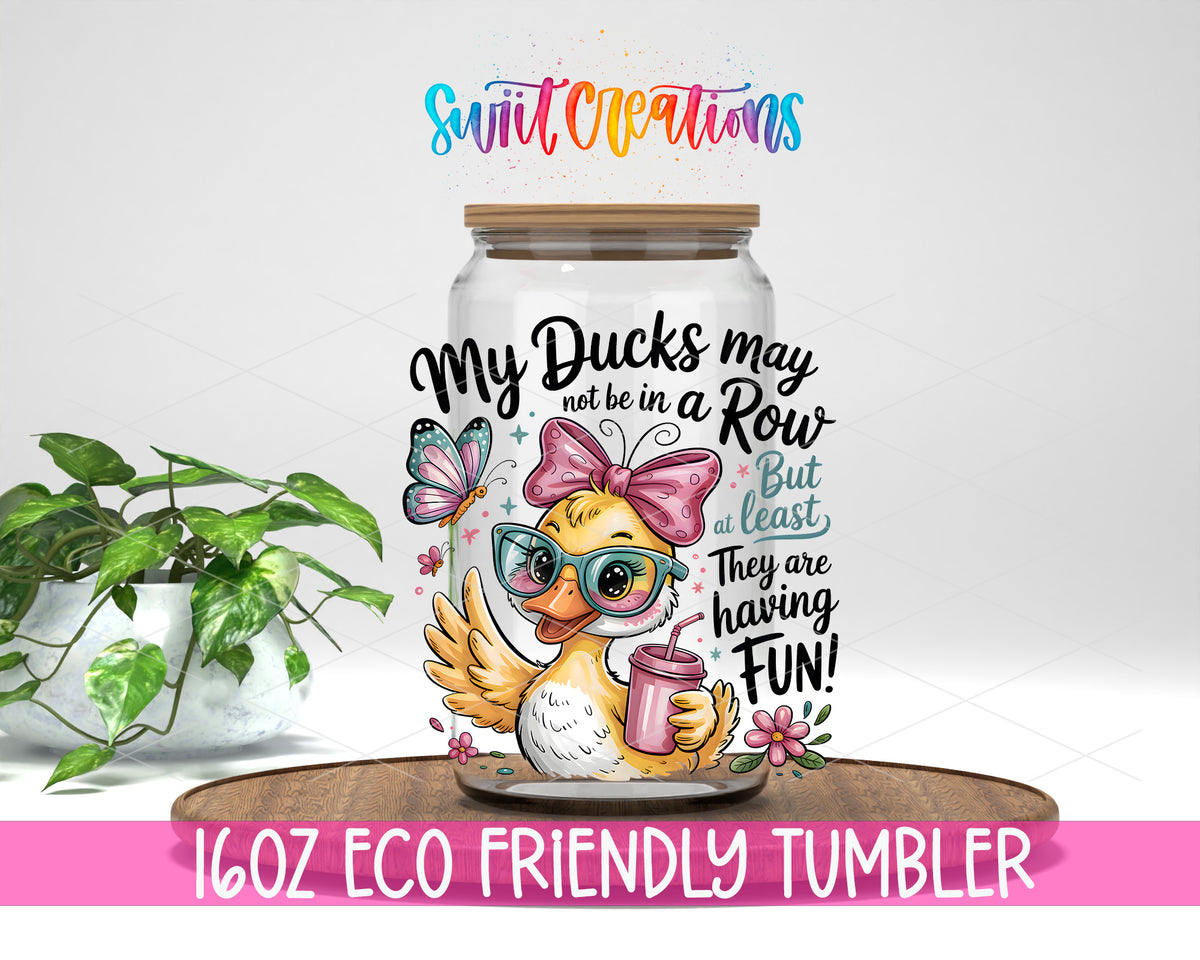 My Ducks May Not Be in a Row design on a 16 oz clear glass tumbler with bamboo lid