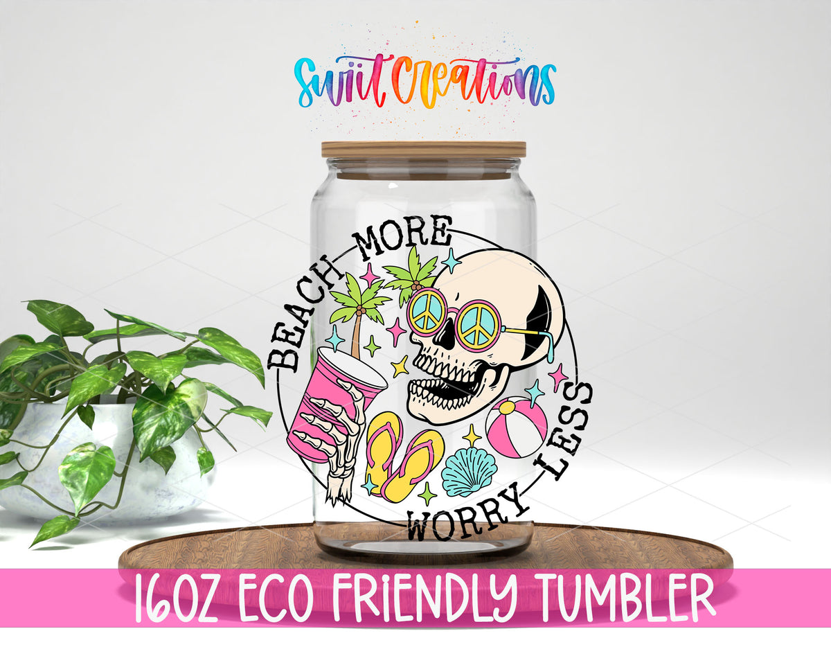 Beach More Worry Less Skull design on a 16 oz clear glass tumbler with bamboo lid