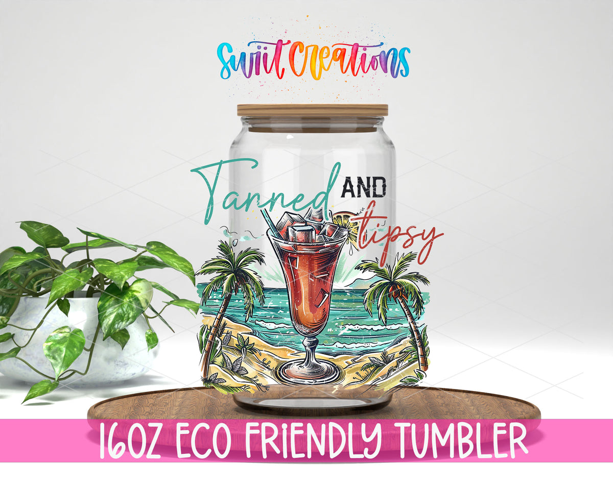 Tanned and Tipsy Tropical design on a 16 oz clear glass tumbler with bamboo lid