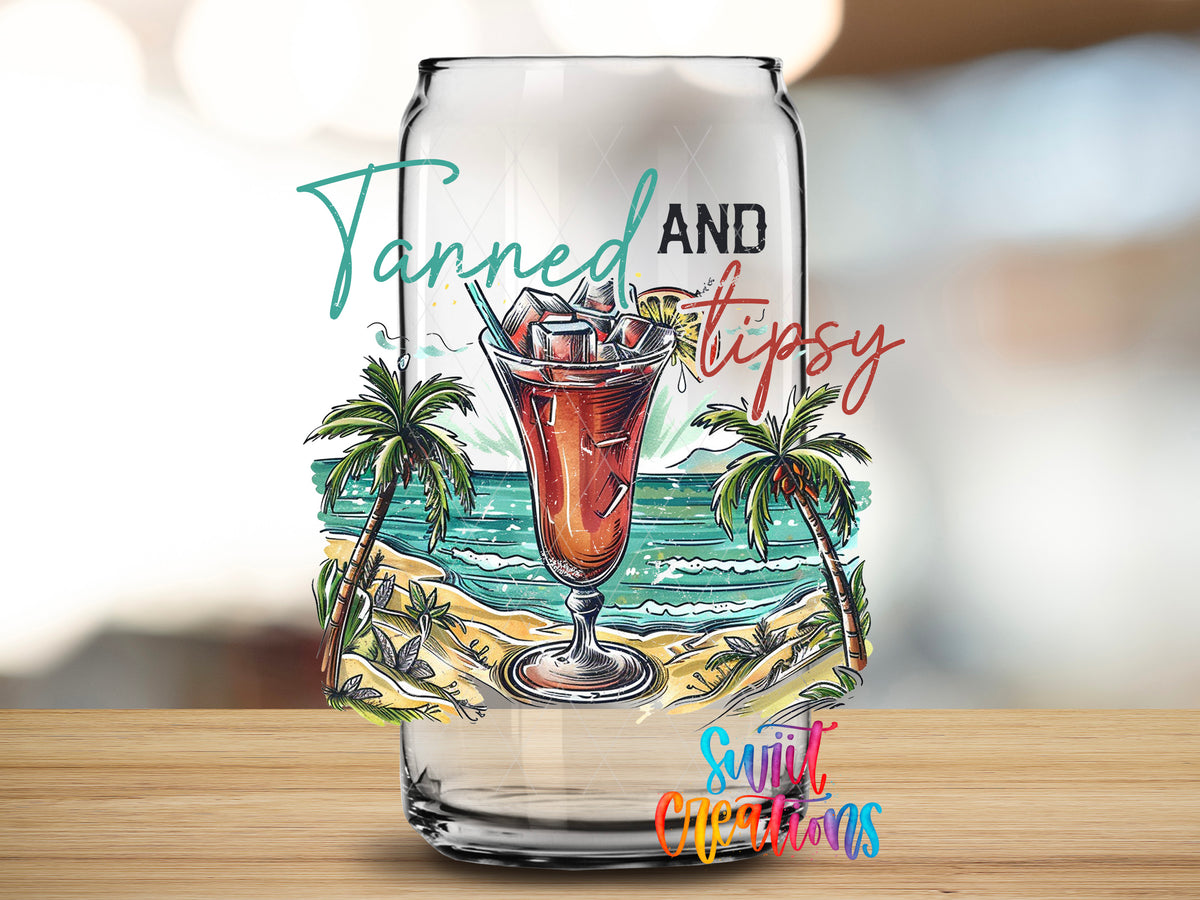 Tanned and Tipsy Tropical design close-up on a clear glass can tumbler