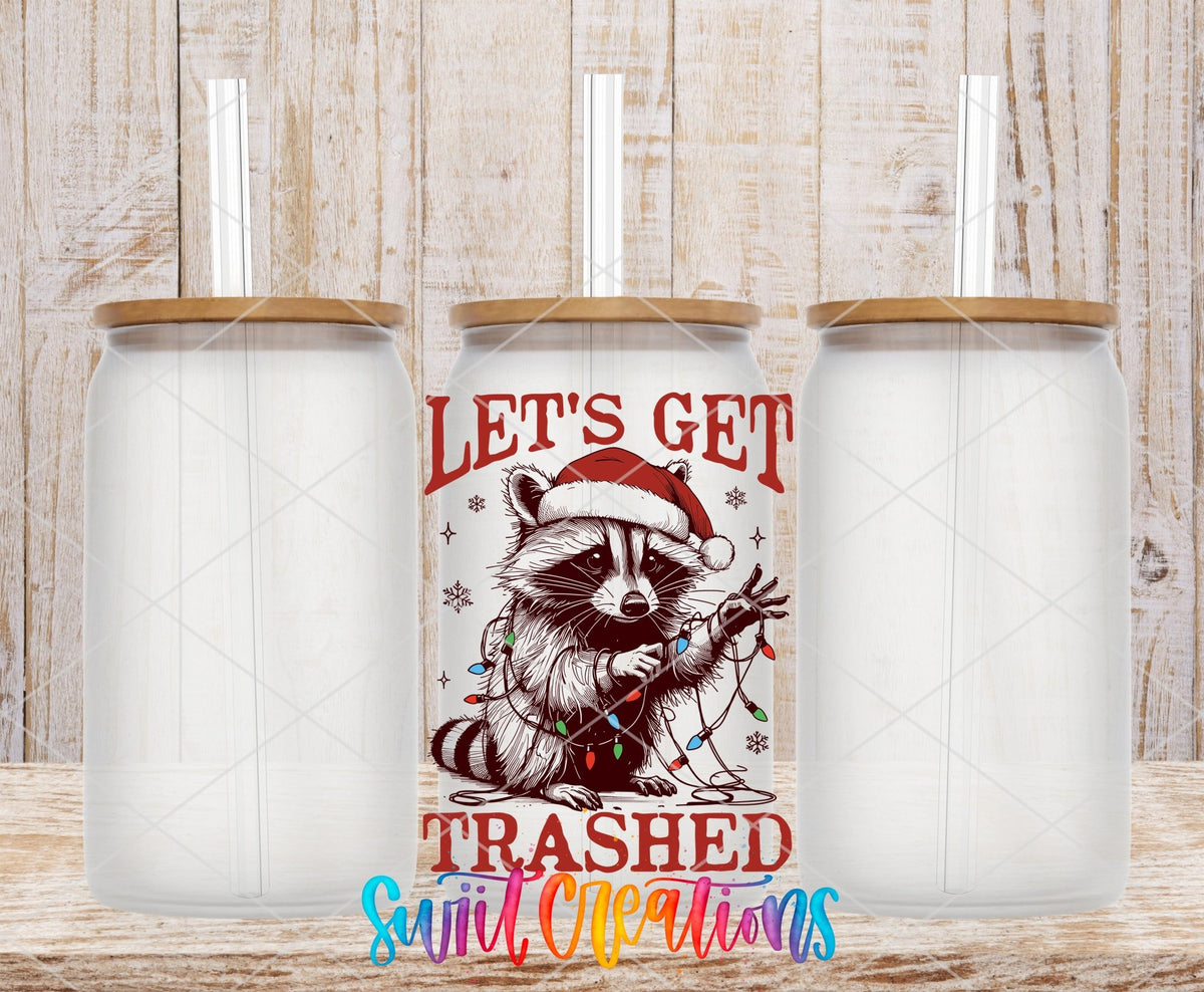 Swiit Creations UV DTF Let’s Get Trashed Christmas Raccoon transfer shown on a clear glass can set