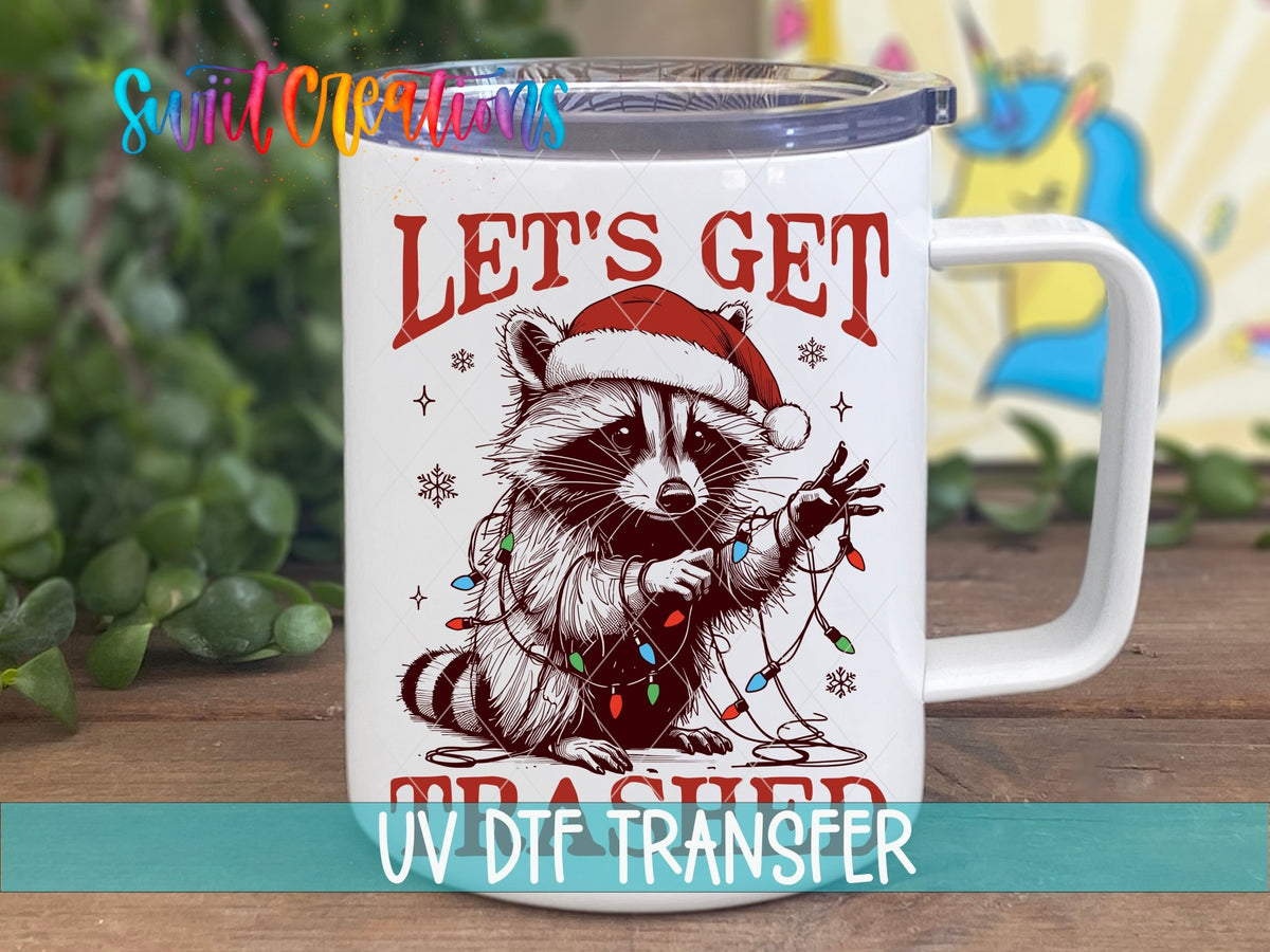 Swiit Creations UV DTF Let’s Get Trashed Christmas Raccoon transfer displayed on a white coffee mug