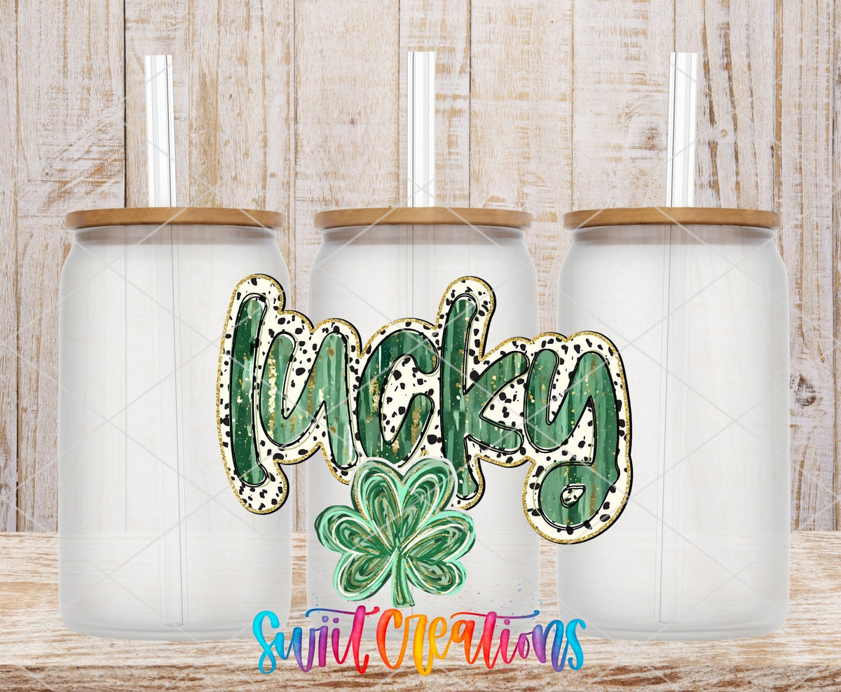 Swiit Creations UV DTF Lucky transfer shown on a clear glass can set