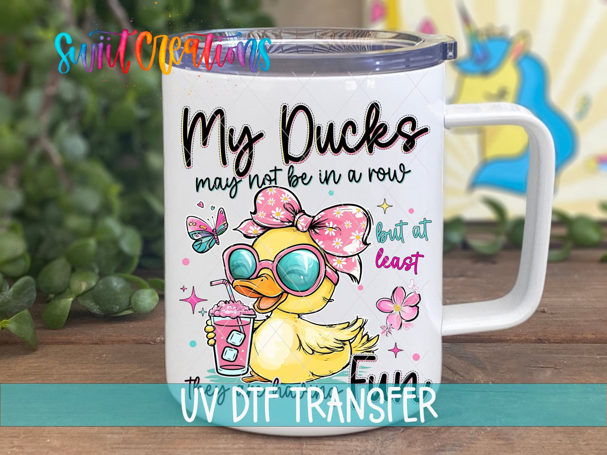 My Ducks May Not Be In A Row UV DTF transfer displayed on a white coffee mug from Swiit Creations
