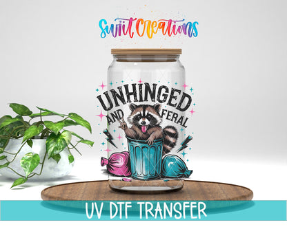 Unhinged and Feral Sassy Raccoon UV DTF transfer displayed on a clear jar mockup from Swiit Creations